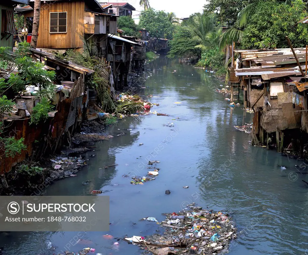 Slum, filthy canal, huts, poverty, waste