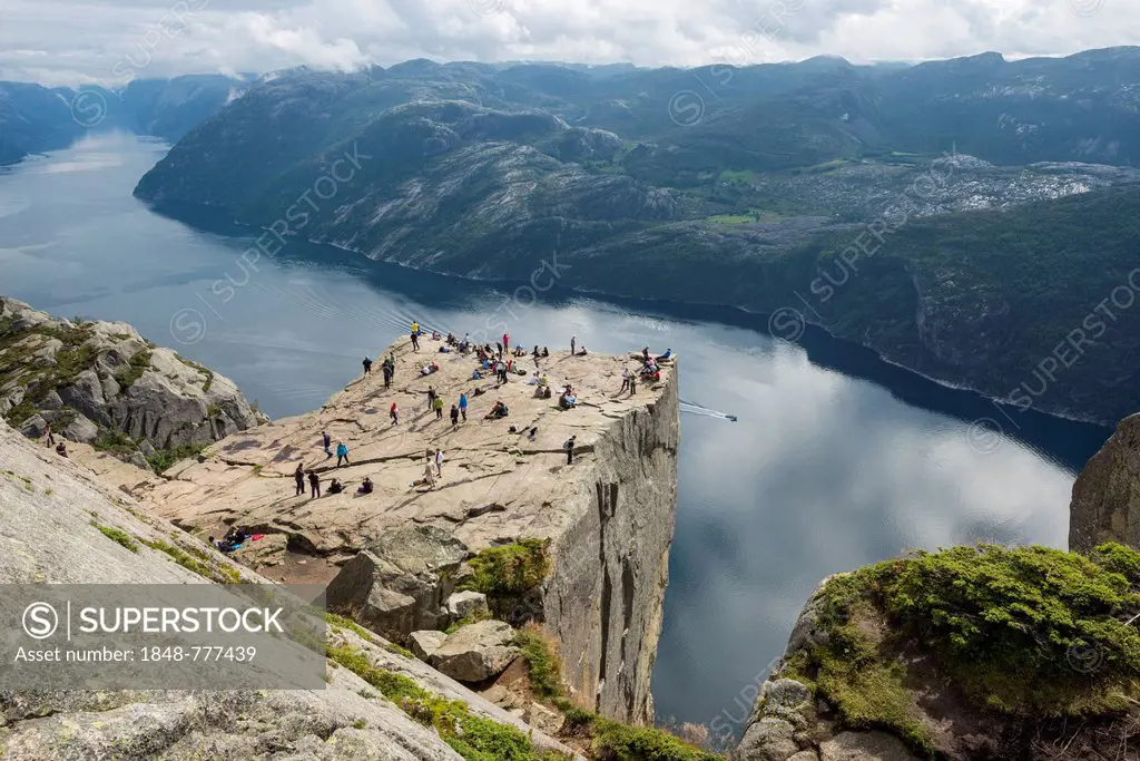 Preikestolen or Prekestolen, Preacher's Pulpit or Pulpit Rock with tourists, views across the fjord landscape