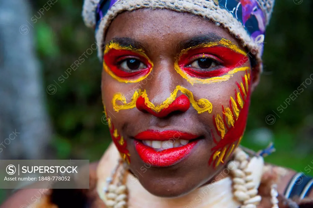 Girl with colourful decorations and face paint is celebrating at the traditional Sing Sing gathering in the Highlands