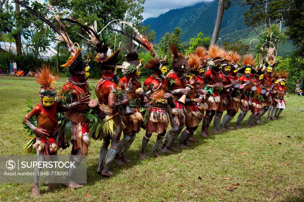 Tribal members in colourful decorations and face paint are celebrating at the traditional Sing Sing gathering in the highlands