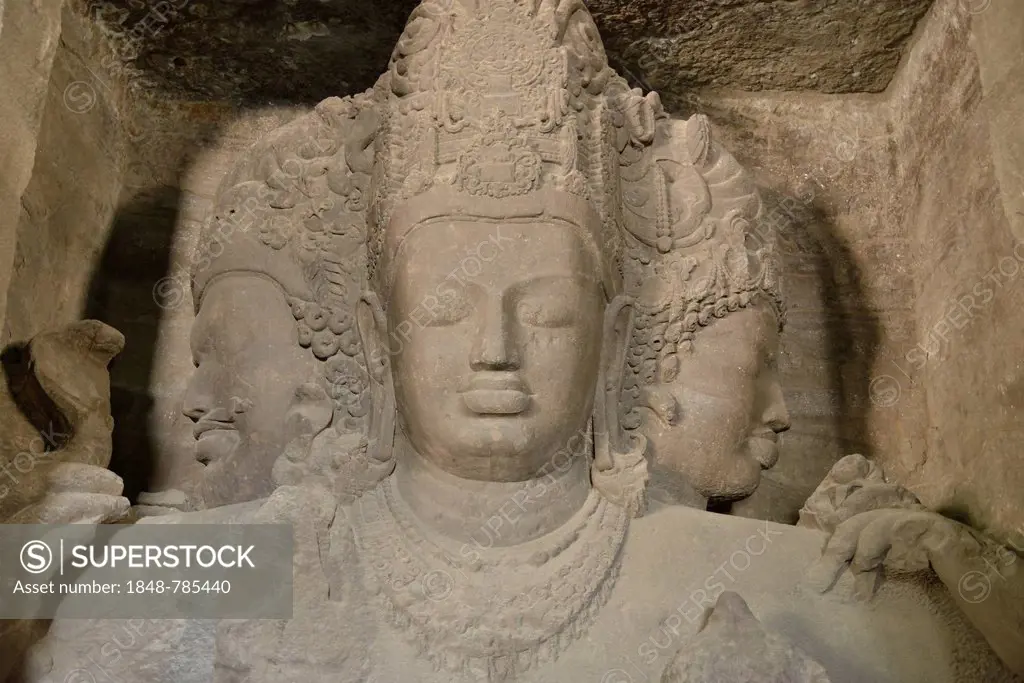 Figure of a three-headed Shiva in the main cave of the Shiva temple on Elephanta Island, UNESCO World Heritage Site