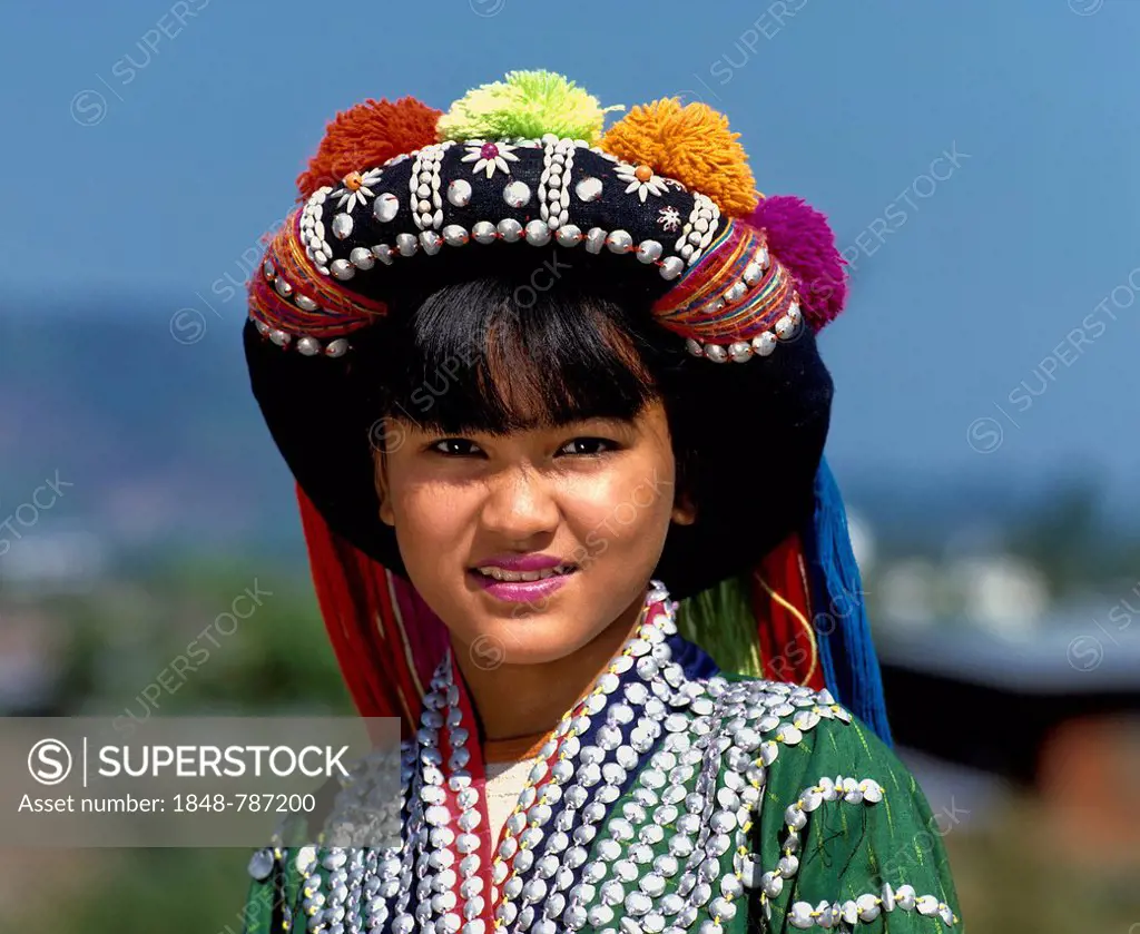 Lisu girl wearing a colourful headdress and the traditional costume of the mountain people, portrait