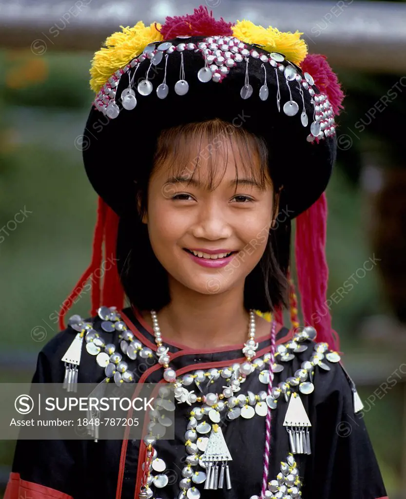 Lisu girl wearing a colourful headdress and the traditional costume of the mountain people, portrait