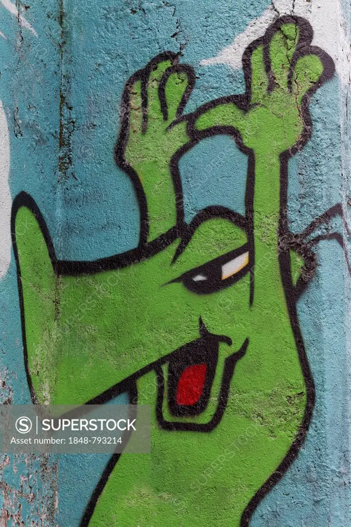 Green cartoon character holding up its hands, graffiti