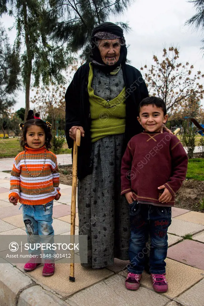 Syrian Orthodox Kurdish woman with tattoos on her face and her grandchildren, Erbil, Arbil Province, Iraqi Kurdistan, Iraq