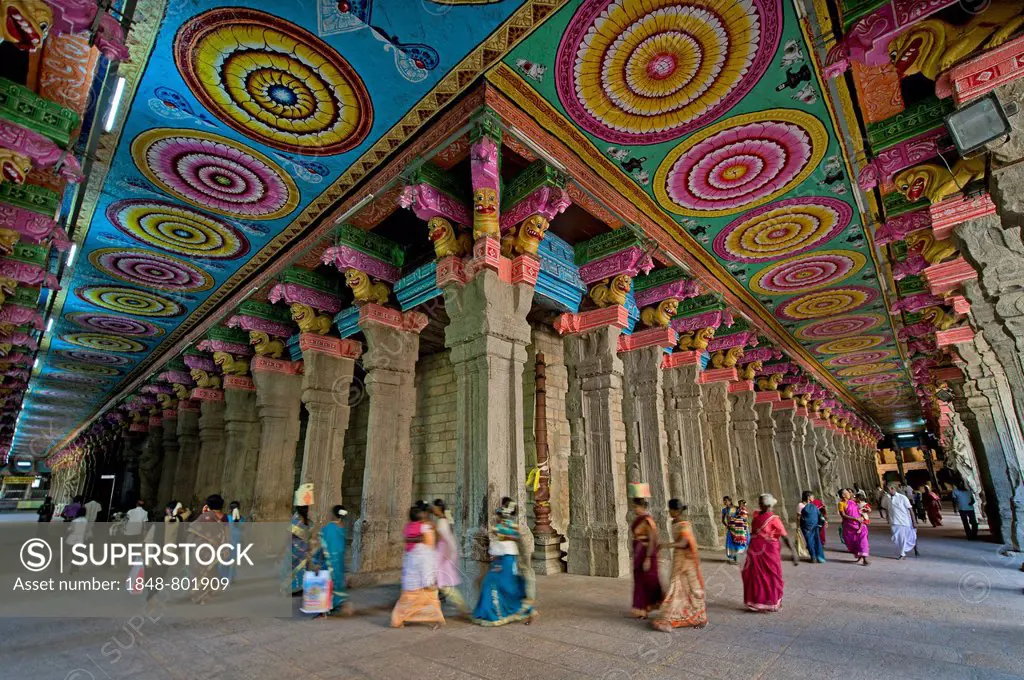 Colourful painted ceiling on stone pillars, temple hall with visitors, Meenakshi Amman Temple or Sri Meenakshi Sundareswarar Temple, Madurai, Tamil Na...