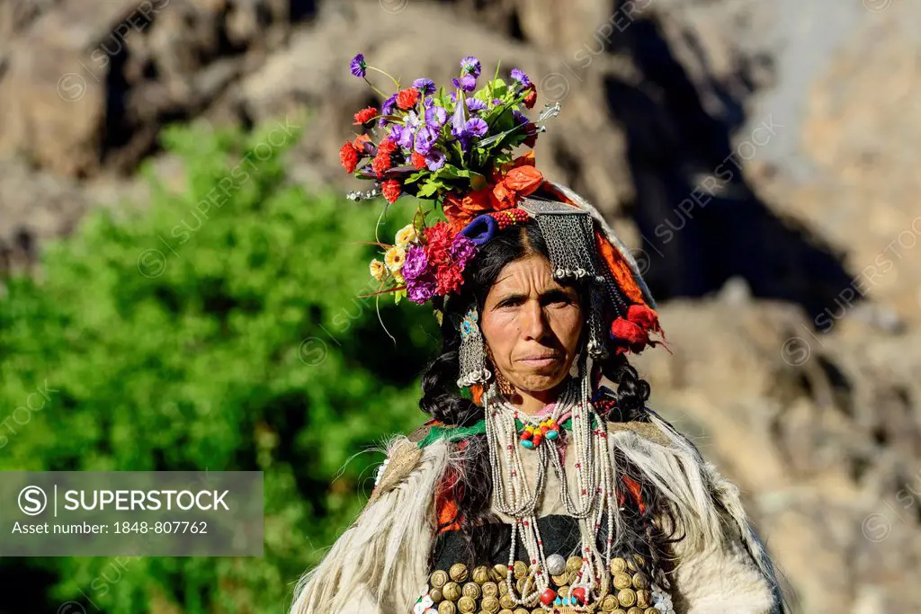 Woman of the Brokpa tribe wearing traditional dress with flower headdress, Dah, Ladakh, Jammu and Kashmir, India