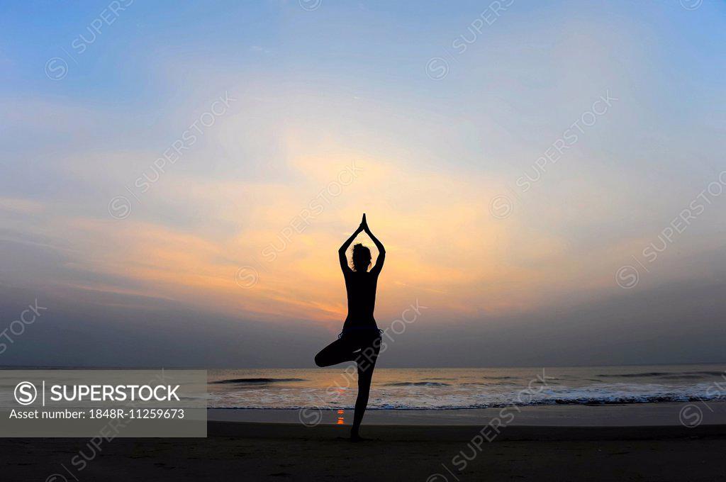 Woman Doing Yoga On A Beach At Dusk Kerala India Superstock