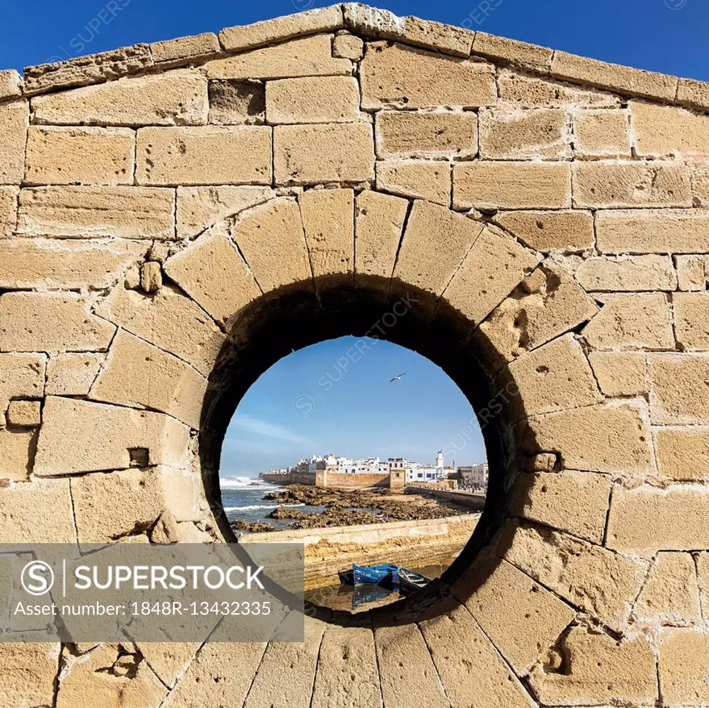 View of the Medina of Essaouira through the wall of the Skala du Port Fortress, UNESCO World Heritage Site, Essaouira, Morocco