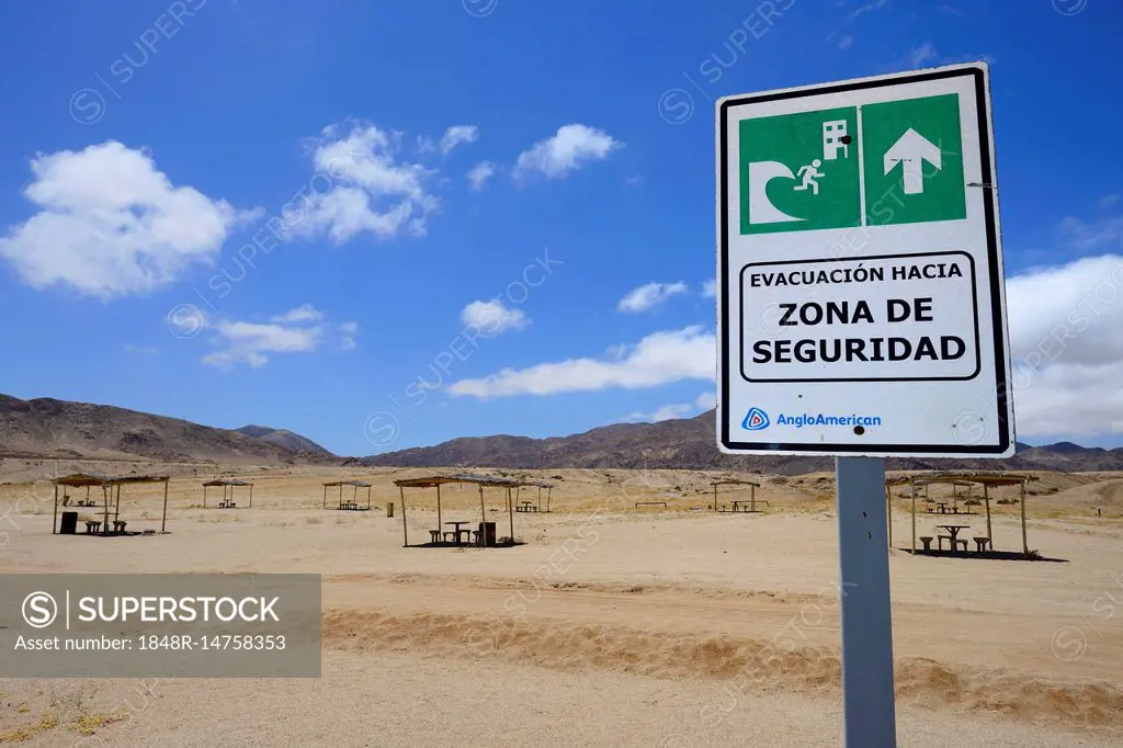 Tsunami warning sign near picnic area on the beach, Pan de Azúcar National Park, near Chañaral, Región de Atacama, Chile