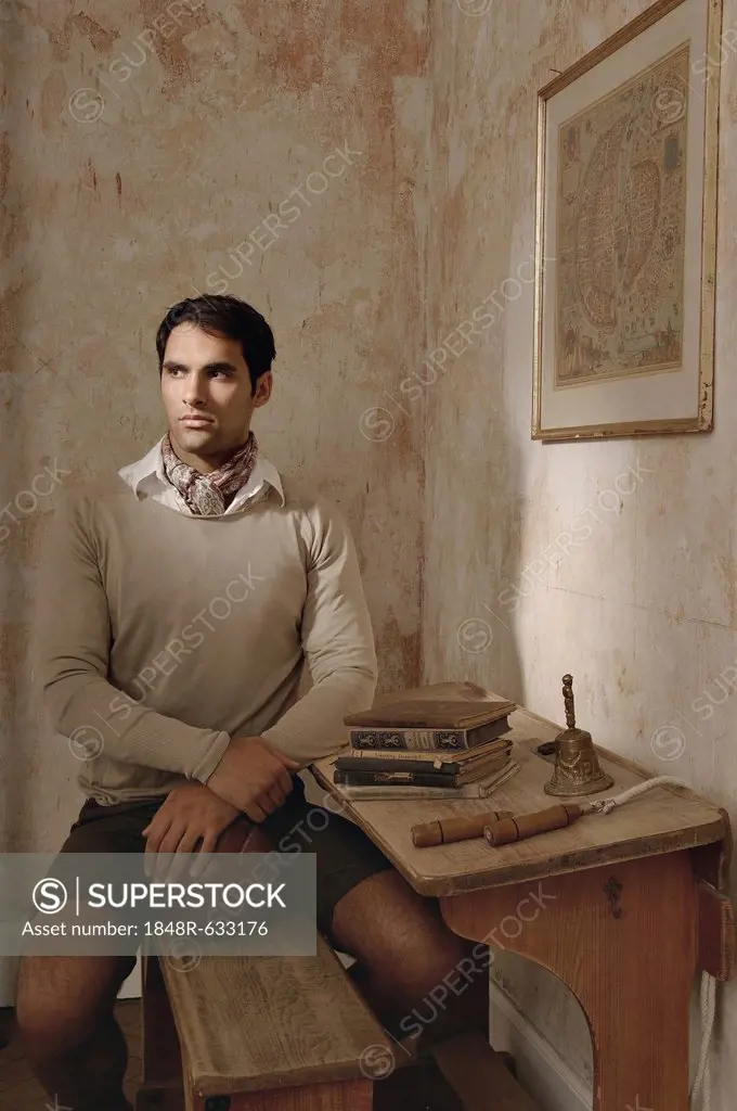 Young mediterranean-looking man in historic school setting