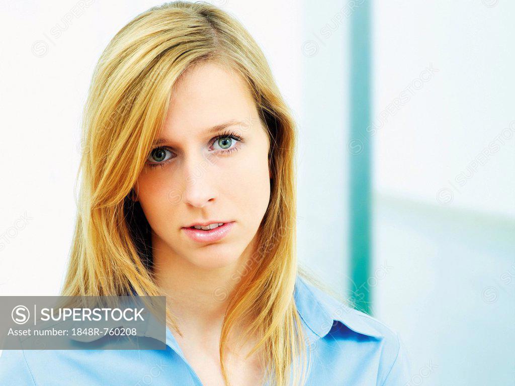 Young Woman Wearing A Blue Blouse Portrait Superstock