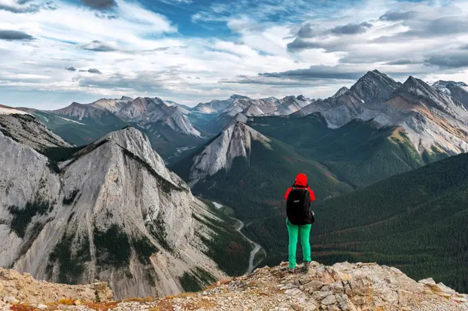 Female hiker views from summit over mountain landscape, panoramic view, Sulphur Skyline Trail, Nikassin Range, Jasper National Park, British Columbia,...