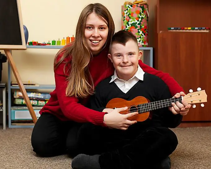 Woman boy with down syndrome posing