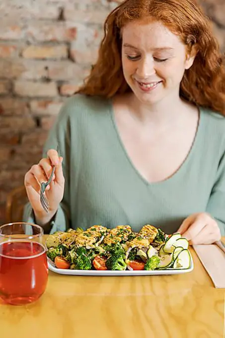 Woman eating vegetarian food medium shot