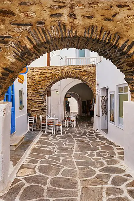 Old narrow alleyways of Greek towns, Medieval arches and streets, whitewashed walls, stone pavement, cozy cafes, bars and restaurants, craft shops, perfect place for tourist stroll, shop and enjoy their vacations. Naoussa, Paros island, Greece, Europe