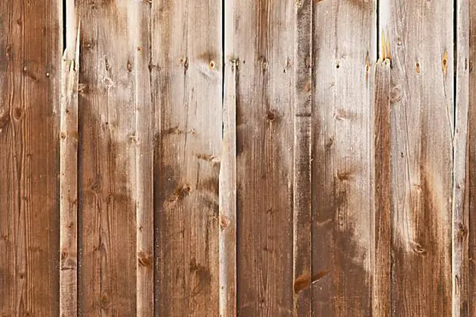 Brown wood background with weathered planks with fading colors