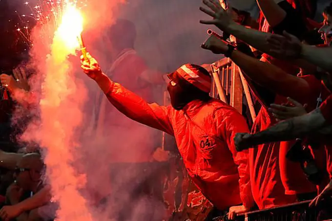 BayArena Leverkusen, 18.5.2023 Football Europa League semi-final second leg Bayer 04 Leverkusen (B04) (red) vs AS Roma (ASR) (white) - Leverkusen fan with pyro flare UEFA REGULATES PROHIBIT ANY USE OF PHOTOGRAPHS AS IMAGE SEQUENCES AND OR QUASI-VIDEO