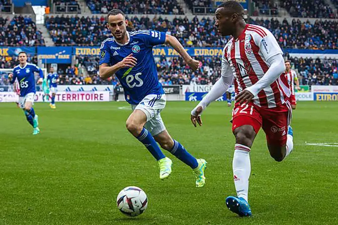 Lucas PERRIN (Racing Strasbourg) in a duel with Cedric AVINEL (Ajaccio)