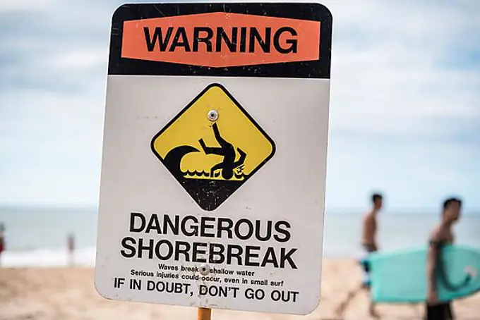 A dangerous shorebreak sign at the beach in the north shore of Oahu, Hawaii, United States, North America