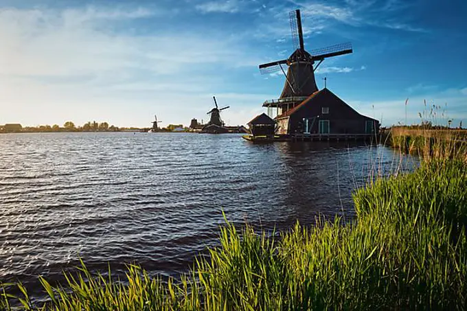 Windmills at famous tourist site Zaanse Schans in Holland on sunset. Zaandam, Netherlands