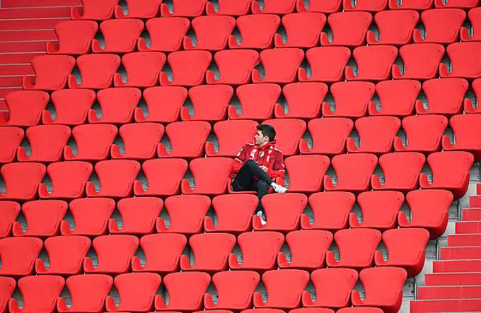 Lone Bayern fan sits in the stands, Allianz Arena, Munich, Bavaria, Germany, Europe