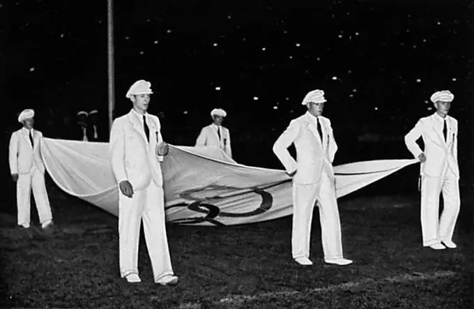 The Atlas cloth of the Olympic flag is taken down by five German Olympic fighters, closing ceremony