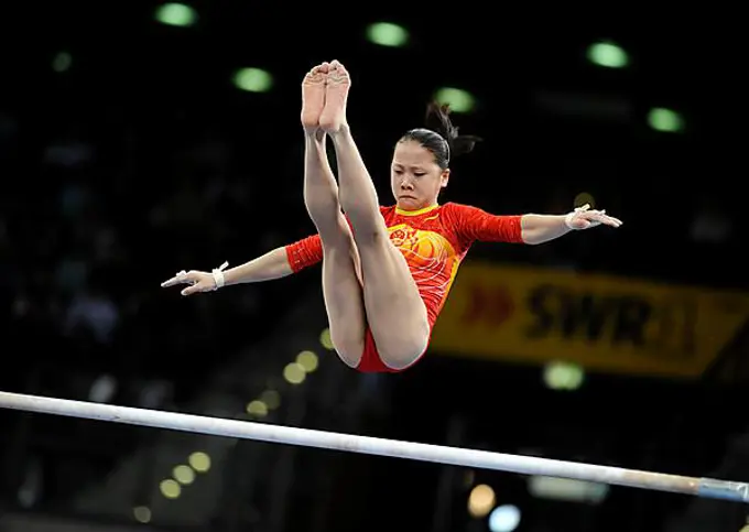 Fei Cheng, China, performing on the asymmetric bars, Gymnastics World Cup Stuttgart 2008, Baden-Wuerttemberg, Germany, Europe