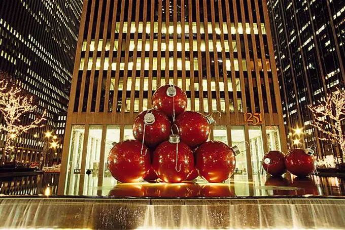 Huge Christmas tree baubles in front of a skyscraper, Upper Midtown, New York City, USA, North America