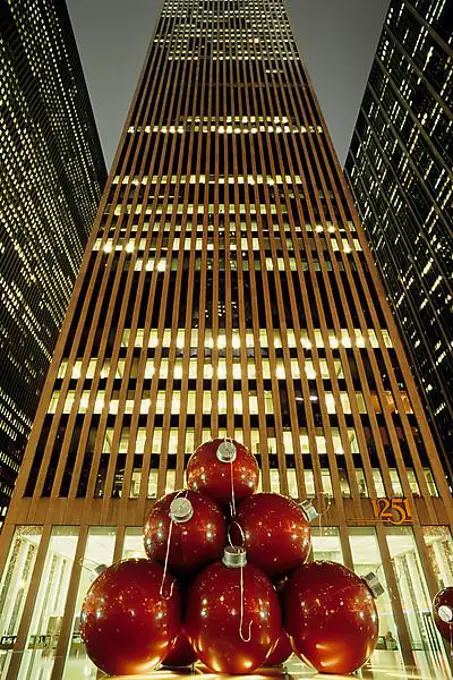 Huge Christmas tree baubles in front of a skyscraper, Upper Midtown, New York City, USA, North America