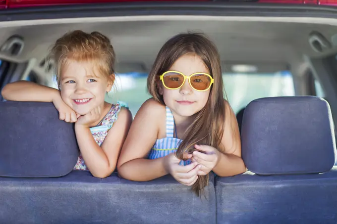 Happy kids in the car. Family on vacation. Summer holiday and car travel concept