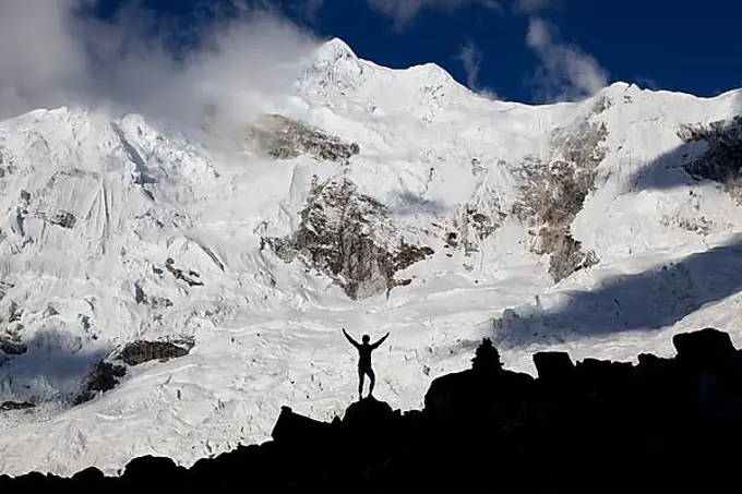 Silhouette of a woman standing in front of Nevado Chopicalqui mountain, Cordillera Blanca mountain range, Andes, Peru, South America