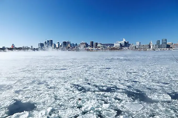 Winter fog over the frozen Saint Lawrence River, view on the City, Montreal, Province of Quebec, Canada, North America