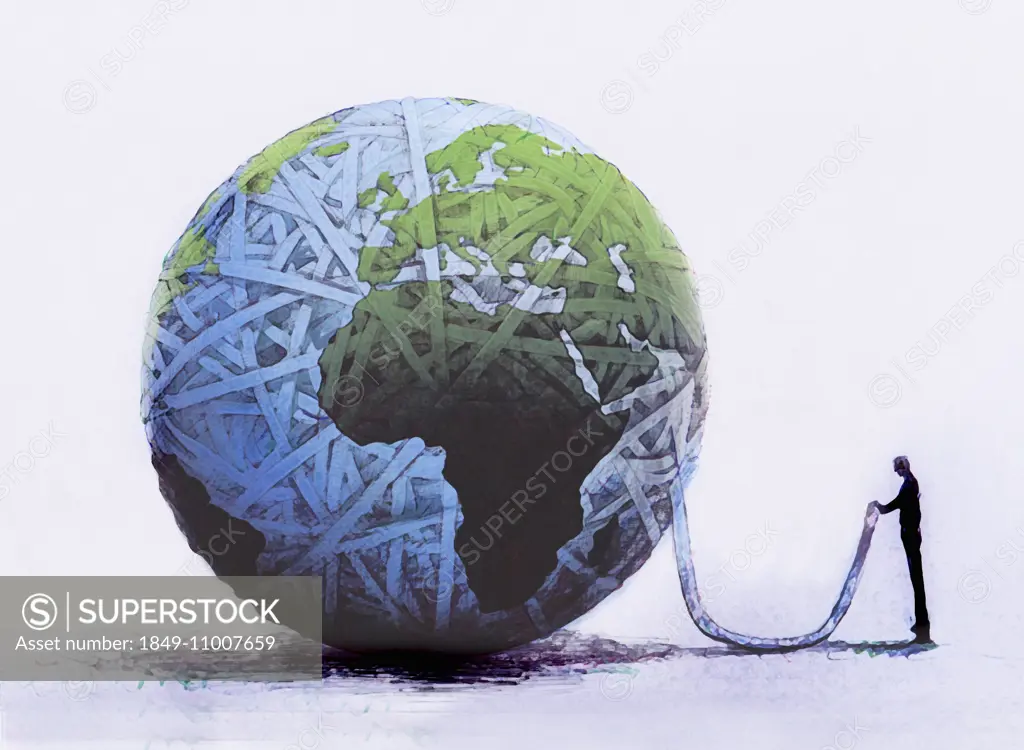 Businessman holding end of rope from unraveling globe ball