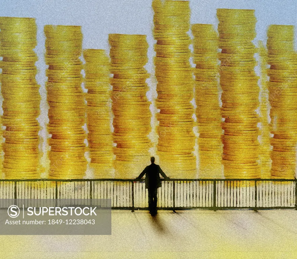 Businessman looking at large piles of money