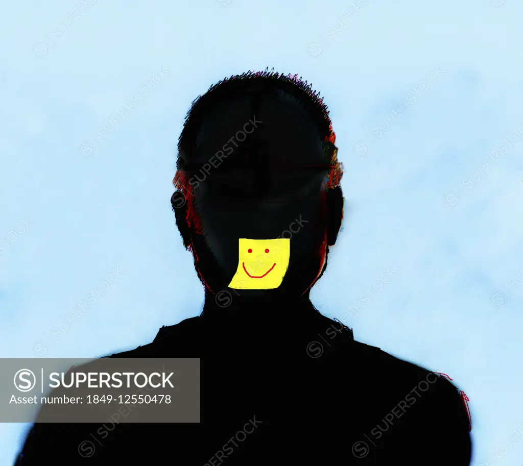 Yellow sticky note with smiley face on silhouette of man's face