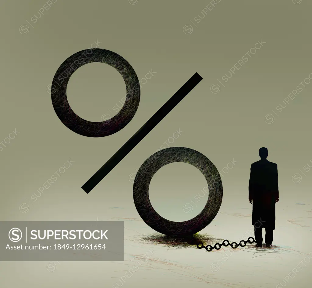 Businessman attached to percentage sign ball and chain