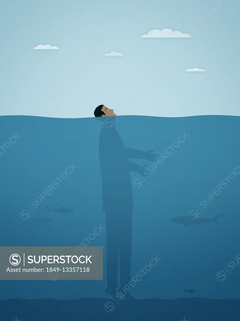 Businessman on tiptoes on seabed with face above water