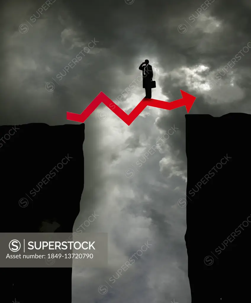 Businessman on top of arrow graph bridging the gap between two cliffs