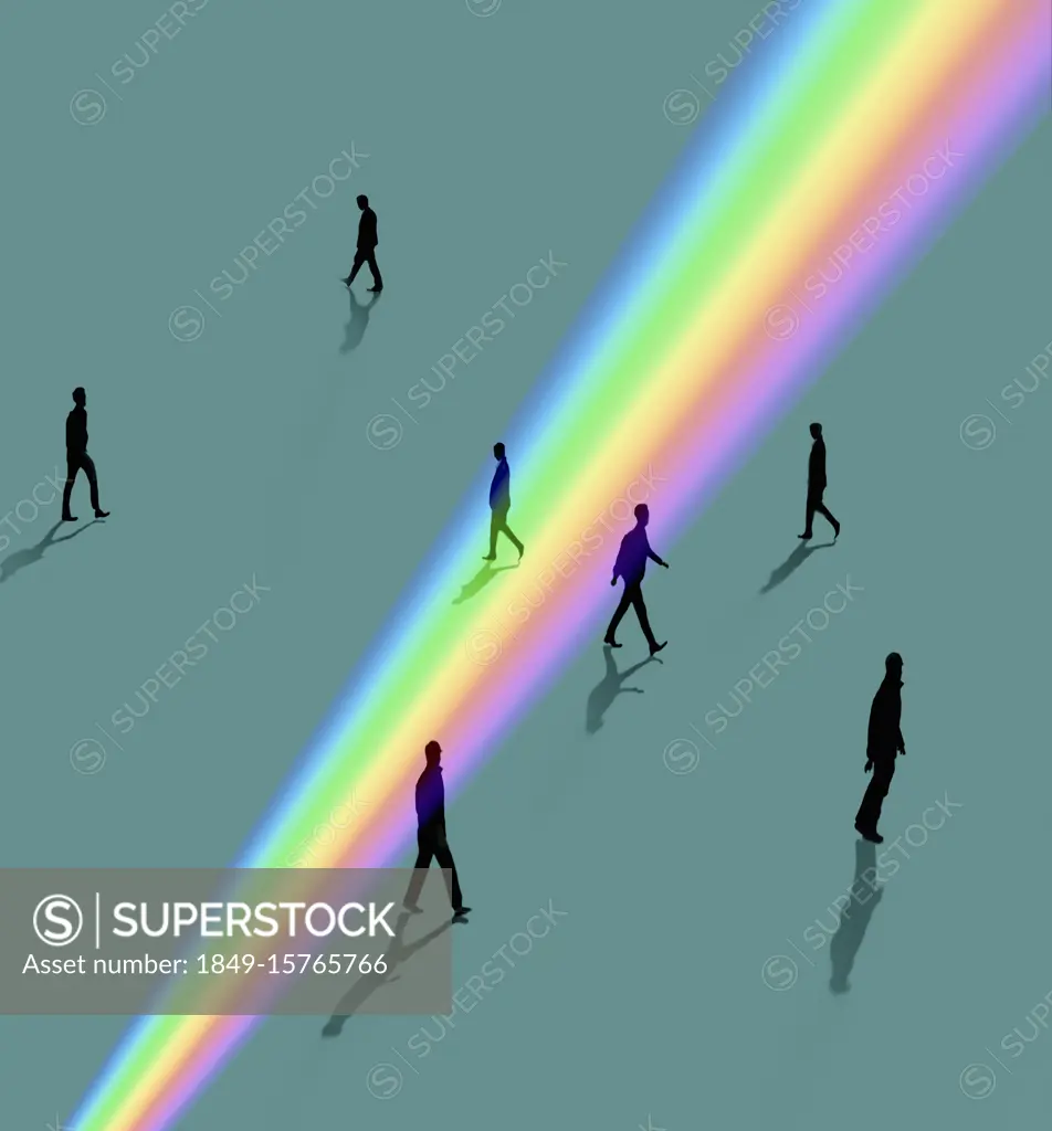 Silhouettes of people walking through rainbow light