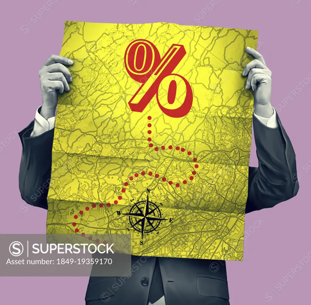 Businessman reading map with path to percentage sign