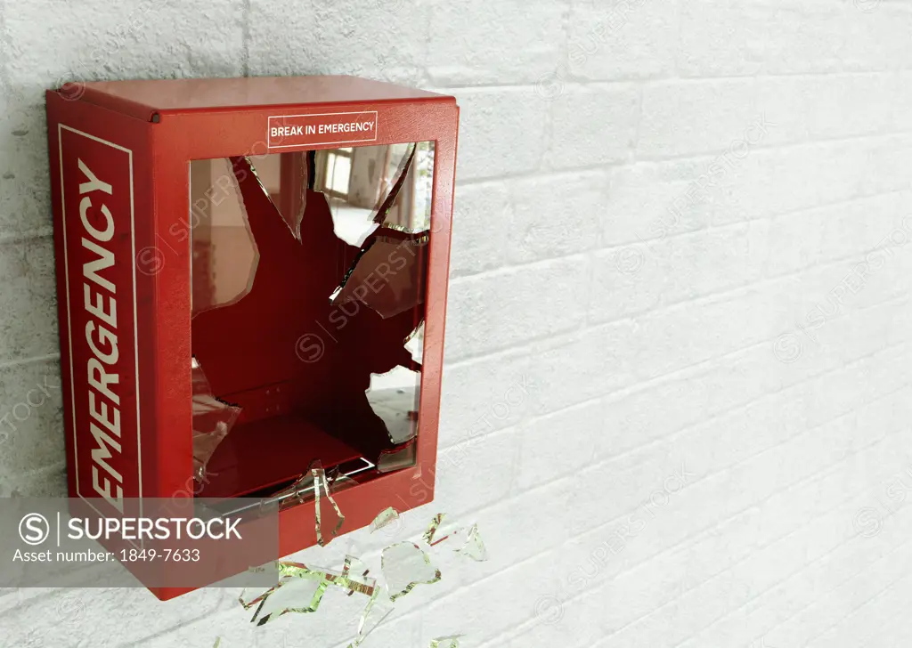 Empty red emergency box with broken glass