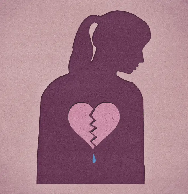 Silhouette of woman with a broken heart