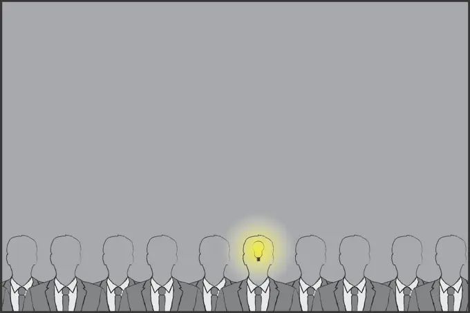 Businessman with light bulb lit up in head standing out from the crowd