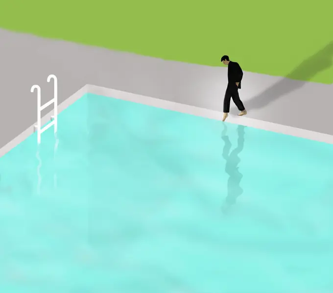 Businessman putting toe in swimming pool water