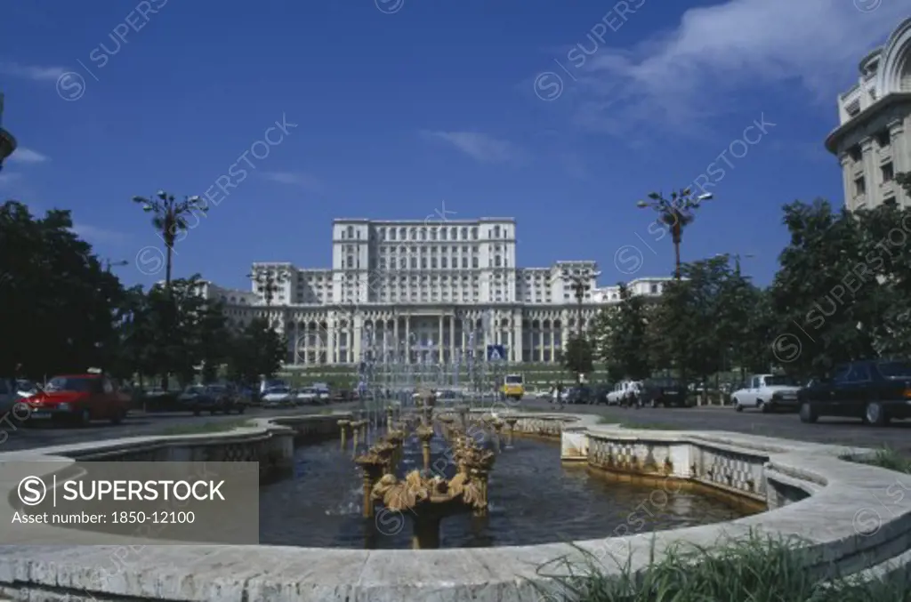 Romania, Bucharest, House Of The Republic.  Palace Of Former Communist President Nicholae Ceausescu.  Exterior Facade With Pool And Fountain In The Foreground.