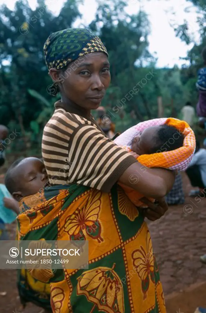 Tanzania, West, Great Lakes Region, Mkugwa Refugee Camp.  Portrait Of Woman With Two Babies.