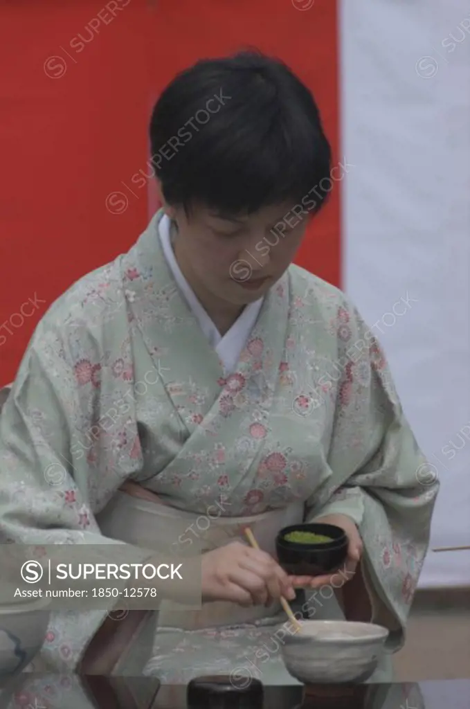 Japan, Chiba, Yokaichiba, 'Licensed Tea Master, Chiharu Koshikawa, Prepares Green Tea, ''Macha'' At A Tea Ceremony And  Places ''Macha'' Green Tea Powder In Bowl'