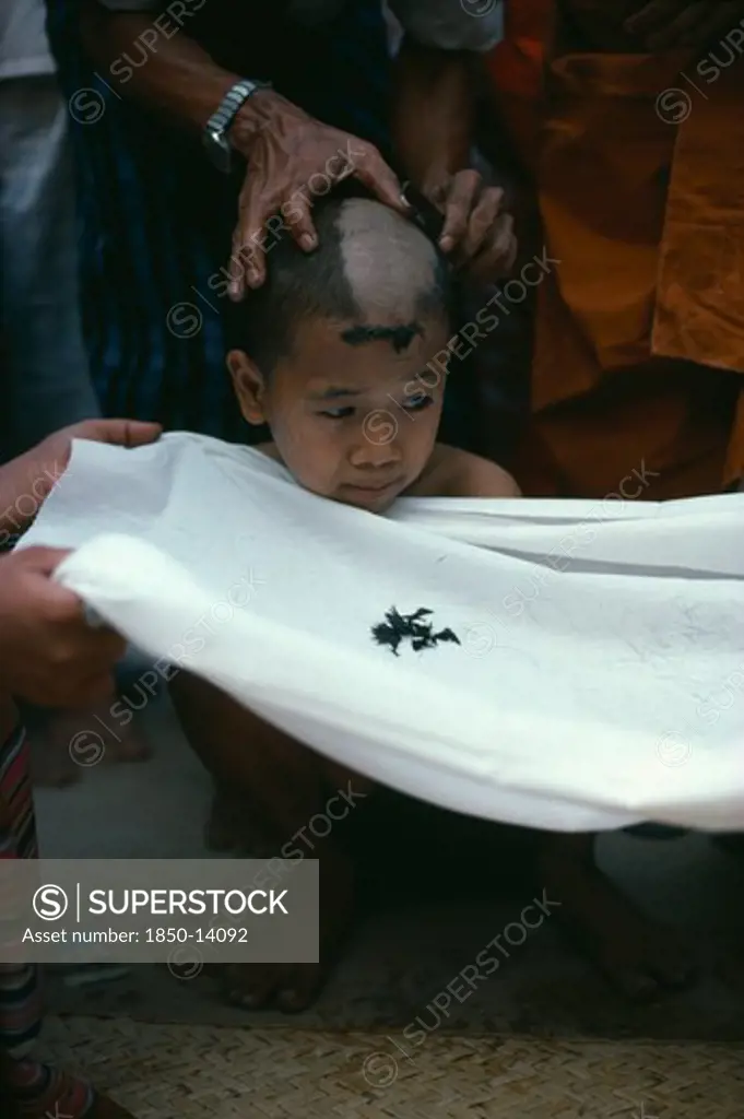 Myanmar, Yangon, Initiate Monk During Ritual Head Shaving.