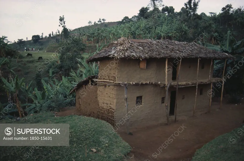 Uganda, Traditional Housing, Two Storey Mud Brick House With Thatched Roof In Rural Area Near Mbale.